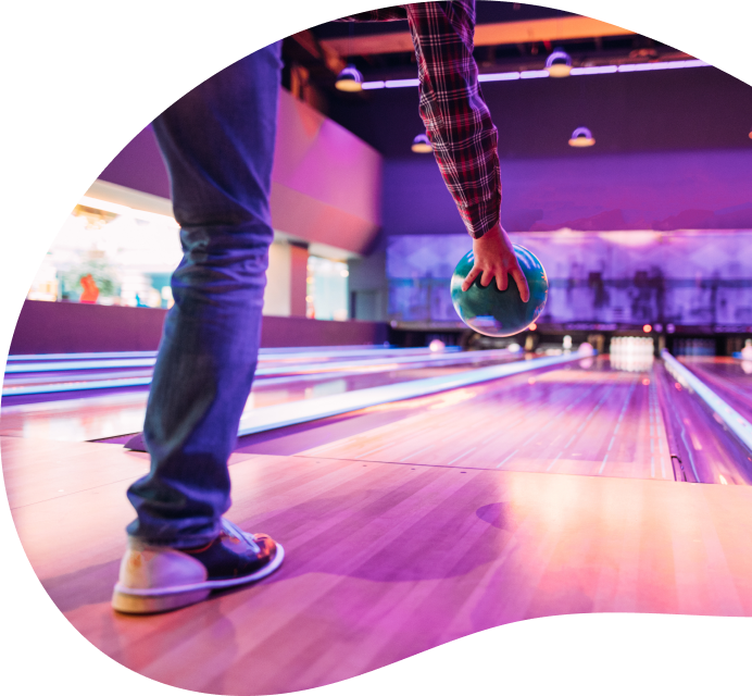 Man about to bowl a bowling ball at Rogue Leisure's bowling alley in Aylesbury